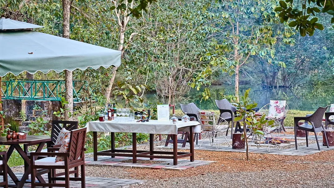 A breakfast table laid under a white parasol