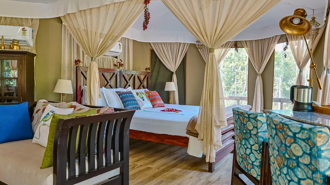 The bed in the Chief's Tent framed by draped curtains