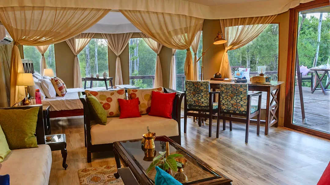 Inside the Chief's Tent: sofas, dining table and bed beneath draped canvas